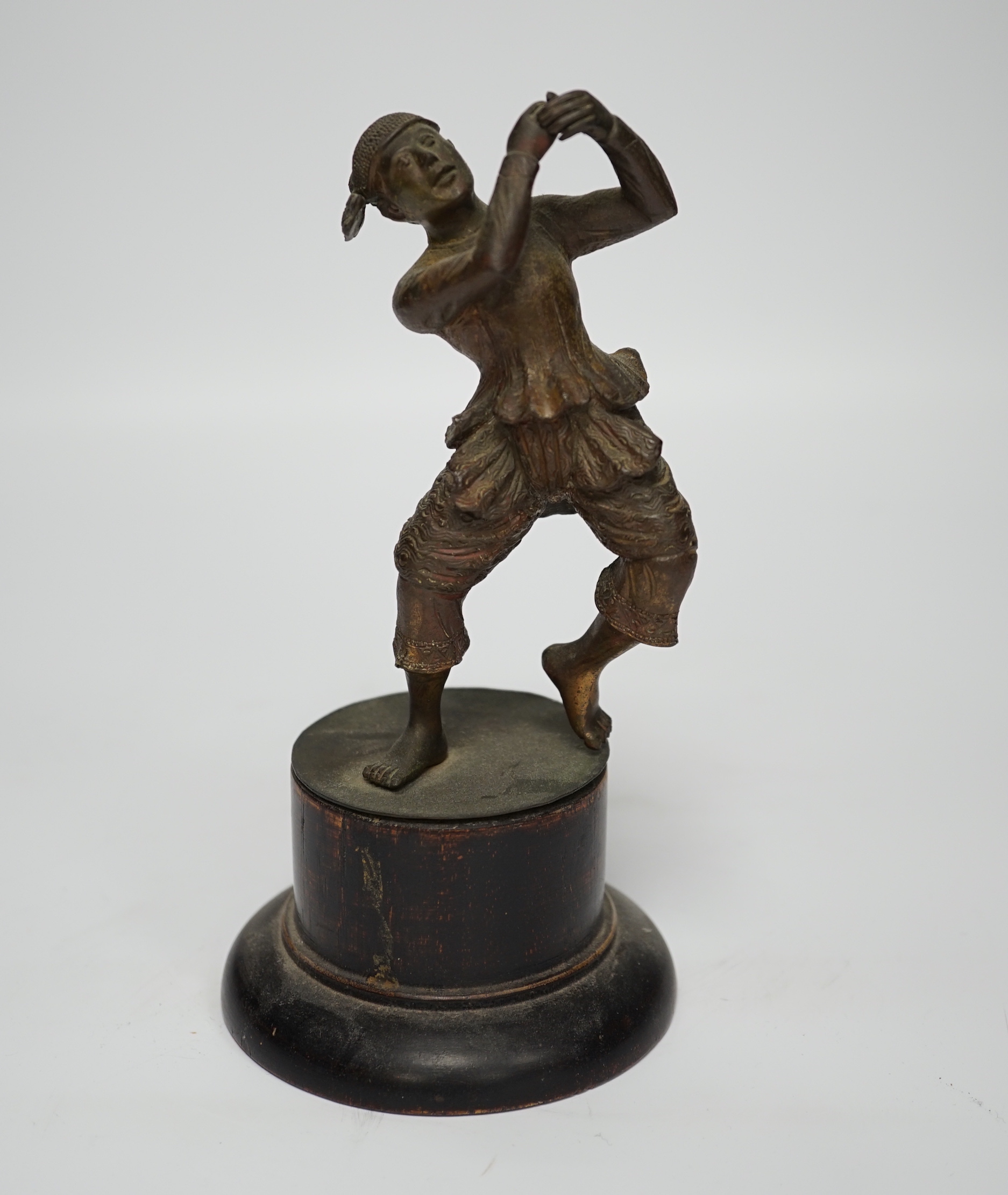 A small bronze figure of a Javanese dancer on a wooden base, 18.5cm